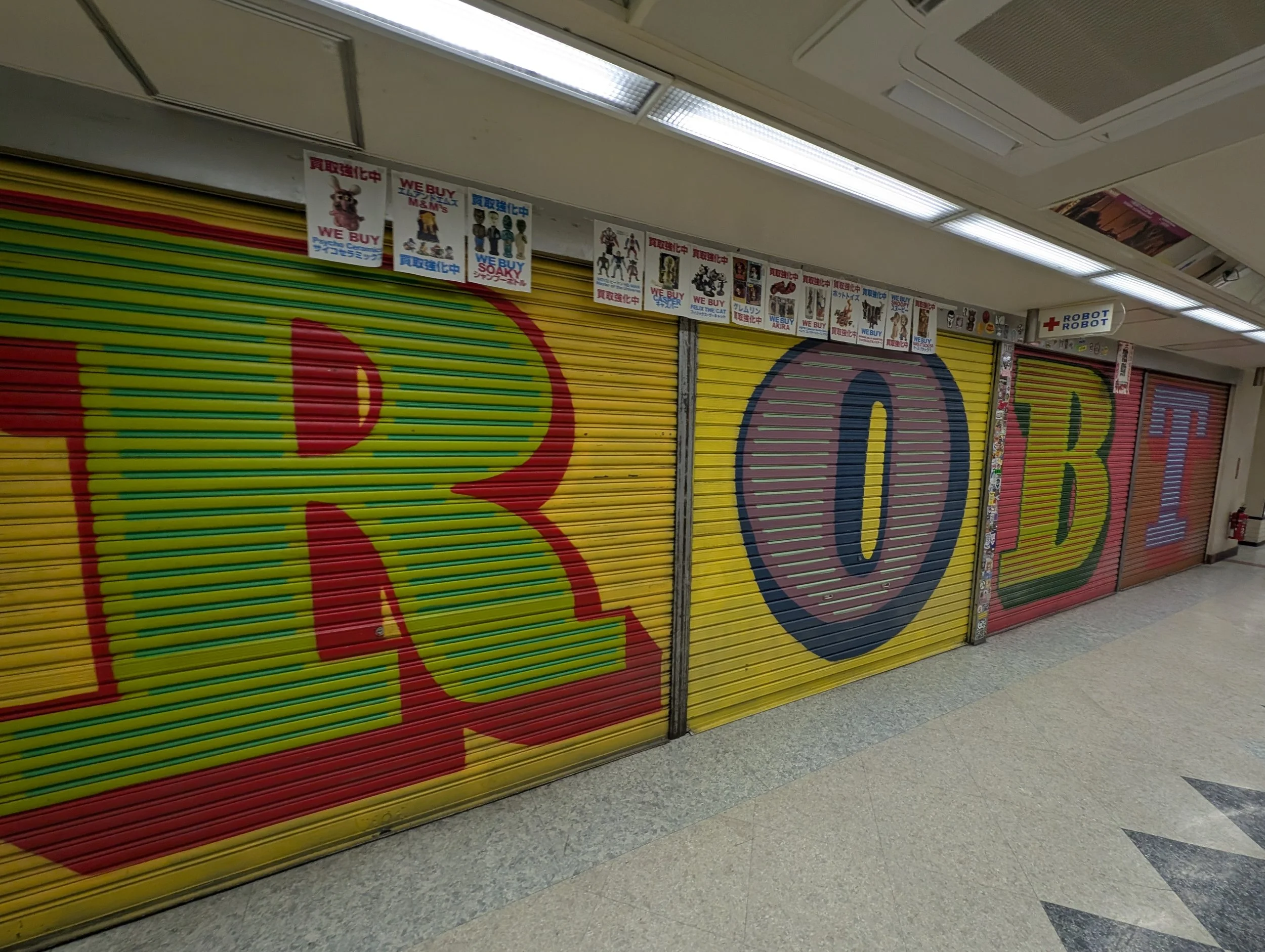 A shop aisle with shelves of collectibles and model kits.