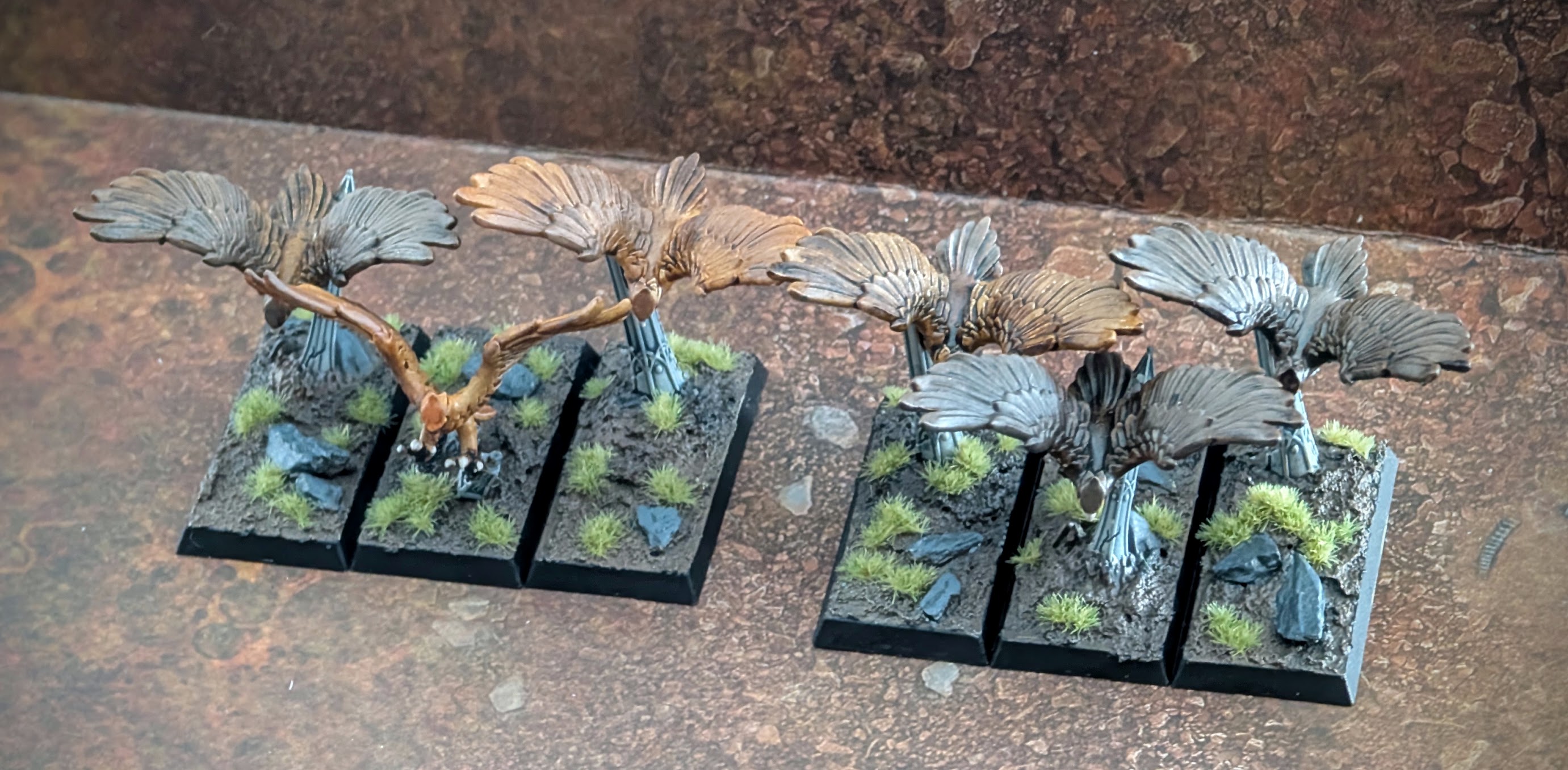 Two painted units of great eagles on movement trays.